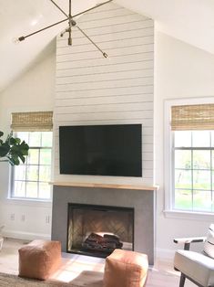 the living room is clean and ready to be used as a tv over the fireplace