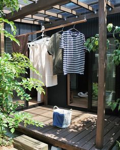 clothes are hanging outside on a wooden deck