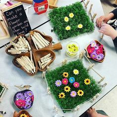 some grass and flowers are on display at a craft fair with sticks sticking out of them