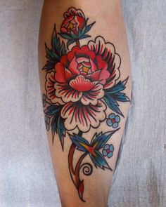 a woman's leg with a flower tattoo on it