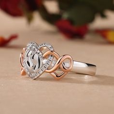 Perfect for mom or mom-to-be, this two-tone sweet ring is a lovely testament to baby love. Crafted in sterling silver, this design features two footprints wrapped in a heart frame of smaller round stones. Two rose gold tone infinite hearts linked with the top of the ring, completing this sweet design. Heart is one of the most popular design elements in jewelry. It's often related with love. Treat her with this cute ring on a special day!Carat Weight: 0.236 ctStone Size: 1,0.8 mmStone Type: Jeulia® StoneNumber of Stones: 24 Stone Shape: RoundStone Color: Diamond WhiteWeight: 3.77 gWidth: 2.7 mmHeight: 3.7 mmThickness: 1.4 mmMaterial: 925 SilverPlating Color: Silver, Rose Gold Mother's Day Promise Heart Ring In White Gold, White Gold Heart Promise Ring For Mother's Day, Mother's Day Promise White Gold Heart Ring, Personalized White Gold Heart Ring For Mother's Day, Silver Heart Ring For Mother's Day Promise, White Sterling Silver Heart Ring With Birthstone, Silver Heart Ring For Anniversary Mother's Day, Silver Heart Ring For Anniversary, Mother's Day, White Heart Ring For Mother's Day