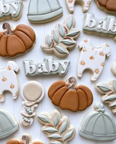 decorated cookies are arranged in the shape of baby's first names and pumpkins