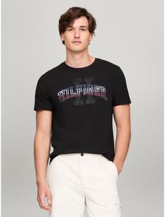 Tommy Hilfiger men's T-shirt. Made from lightweight cotton jersey, known for its breathability and stretch, our comfortable crewneck tee is cut in an easy fit and finished with our Hilfiger graphic.  Material: 100% Cotton. Tommy Hilfiger Graphic Print T-shirt For Streetwear, Tommy Hilfiger Sporty T-shirt With Graphic Print, Tommy Hilfiger Sporty Graphic Print T-shirt, Tommy Hilfiger Sporty Black Tops, Tommy Hilfiger Graphic Tee For Streetwear, Tommy Hilfiger Graphic Tee For Summer, Tommy Hilfiger Summer Graphic Tee, Tommy Hilfiger Graphic Print Crew Neck T-shirt, Tommy Hilfiger Crew Neck T-shirt With Graphic Print