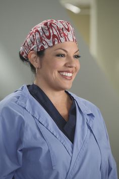 a woman in scrubs smiling at the camera