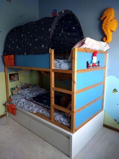 a bunk bed with two sets of mattresses on top of it in a child's bedroom