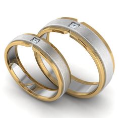 two gold and silver wedding rings with diamonds on each side, set against a white background