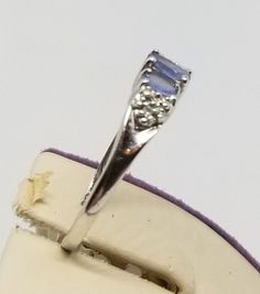 "We do not check prongs for wear or stones for looseness. All items are sold as is-noting that we are a resale shop so everything here had a previous owner! We will include flaws in the description when noted. This is one of the reasons our items are more affordable than new at a jewelry store. Vintage 10K White Gold Ring with Iolite/Tanzanite Stones & Small Diamonds, Size 6.75. Stamped 10K C ♥ inside band. Weighs 1.3 dwt. Please stop in often as we will be adding additional vintage fine jew Tanzanite Amethyst Birthstone Ring For Anniversary, Tanzanite Gemstones For Anniversary, White Gold Tanzanite Birthstone Ring For Anniversary, Silver Tanzanite Birthstone Ring, Tanzanite Multi-stone Ring, Yellow Gold Tanzanite Multi-stone Ring, Anniversary Three-stone Tanzanite Jewelry, Classic Tanzanite Multi-stone Jewelry, European Jewelry