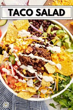 a bowl filled with taco salad and tortilla chips