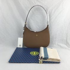 "Nwt Tory Burch Emerson Saffiano Leather Shoulder Bag Details: Saffiano Leather Gold Tone Hardware Zip Closure 1 Interior Slip Pocket Adjustable Shoulder Strap (8.5 In / 13 In) Approx. Measurement: 8.5"" X 5.5"" X 2.5"" In Smoke Free Home!! All Items Are Guaranteed 100% Authentic And Brand New !" Tory Burch Emerson, Bag Details, Tory Burch Bags, Tory Burch Bag, Brown Gold, Womens Tote Bags, Leather Shoulder Bag, Tory Burch, Shoulder Strap