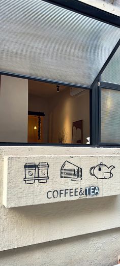 there is a coffee and tea sign on the wall