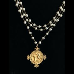 -The Notre Dame de Lourdes Trinity Necklace features three strands of 6mm Freshwater Pearls hand wrapped in 24kt gold dipped chain. It is a medal that was given to Pilgrims to the Holy Waters and apparition site of Lourdes, France. The M in the center honors the Blessed Mother and the 12 Roses surrounding it are symbolic of the Apostles and the 12 Tribes of Israel. Regardless of your faith background, Her presence is a protective and healing balm and a holy medal is a tangible reminder of Her lo Gold Double Strand Spiritual Necklaces, Spiritual Double Strand Gold Jewelry, Spiritual Gold Double Strand Jewelry, Gold Multi-strand Spiritual Jewelry, Handmade Gold Multi-strand Pearl Necklace, Handmade Multi-strand Gold Pearl Necklace, Trinity Necklace, 12 Roses, Healing Balm