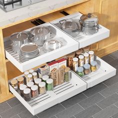 an open drawer in a kitchen with pots and pans on the bottom shelf next to it