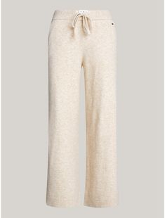 Tommy Hilfiger women's sleepwear. Nothing is better than lounging around in a pair of cozy, loose-fitting sweats—well, these were designed for just that. Made from a blend of nylon, acrylic and wool, woven in a jersey knit for a soft, subtle texture, our wide-leg lounge pant is made complete with an elastic drawstring waistband, pockets, and rib-knit hems.  Material: 47% Recycled Polyester, 33% Polyamide, 13% Acrylic. Cozy Bottoms For Fall Relaxation, Cozy Bottoms For Relaxation In Fall, Cozy Fall Bottoms For Relaxation, Cozy Fall Relaxation Bottoms, Comfortable Beige Pants For Lounging, Beige Pants For Winter Lounging, Casual Fall Bottoms By Tommy Hilfiger, Cozy Beige Bottoms For Relaxation, Tommy Hilfiger Casual Bottoms For Fall