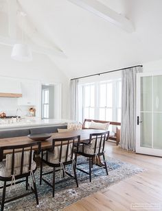 an instagram photo of a dining room table and chairs in front of a kitchen