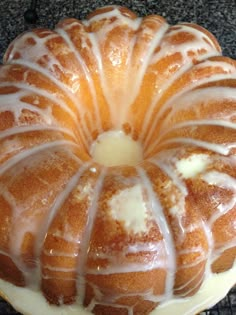 a bundt cake sitting on top of a white plate covered in frosted icing