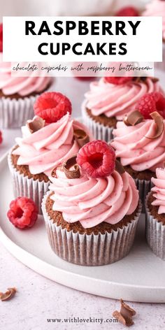 raspberry cupcakes on a white plate with pink frosting