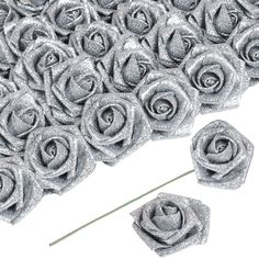 some silver glittered roses on a white background