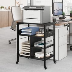 an office desk with printer and computer on it