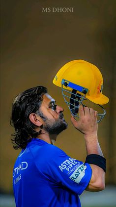 a man wearing a blue shirt and yellow helmet