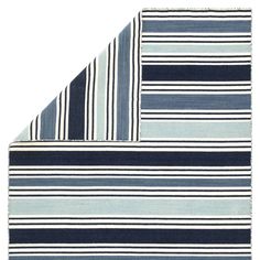 two blue and white striped rugs on top of each other