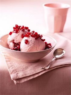 a bowl filled with ice cream and pomegranate