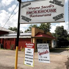 two signs are posted in front of a restaurant