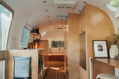 an interior view of a camper with wood paneling