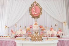 a table topped with lots of cakes and desserts