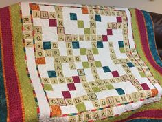 a quilted blanket that has words written on it and the word love spelled in multiple languages