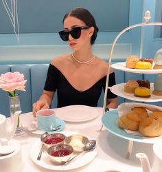 a woman sitting at a table with plates of food