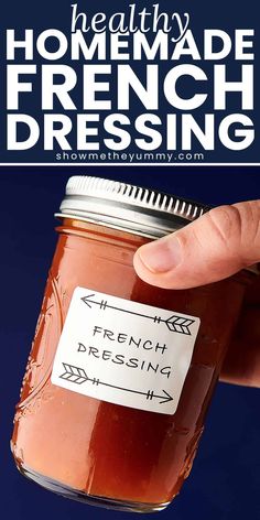 a hand holding a jar of homemade french dressing with text overlay that reads how to make homemade french dressing