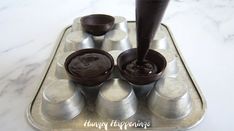 an image of chocolate fondant being made in a pan on the stove top with spoons