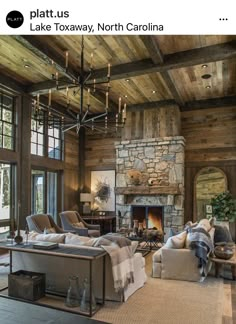 a living room filled with furniture and a fire place in the middle of a room