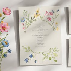 the wedding stationery is decorated with watercolor flowers