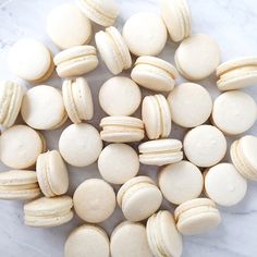 macaroons are arranged on a marble surface