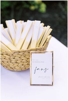 a basket filled with matchesticks next to a sign on top of a table