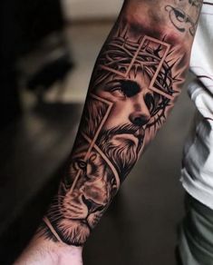 a man with a lion and cross tattoo on his arm