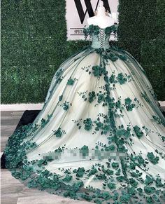 Discover elegance and sophistication with the Princess Ball Gown Green Quince Dress! This gorgeous piece features floral beading, beautiful crystals, and an off-the-shoulder design for a timeless, classic look. Feel like a princess in this exquisite dress for your special celebration! Catalogue: Crystals Floral Quinceanera Dresses GreenVenues: Hall,Church,Beach / Destination,Garden / OutdoorBack Details: Lace UpSeason: Spring,Summer,Winter,FallNeckline: SweetheartMaterial: 3D FlowersSilhouette: Quinceanera Dresses With Cape And Hood, Quince Dresses With Capes, Quince Dress Sleeves, White And Green Quinceanera Dresses, Quinceanera Dresses With Sleeves, 15 Dresses Quinceanera Green, Olive Green Quinceanera Dresses, Quince Dresses Green, Elegant Quinceanera Dresses