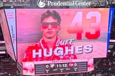 a large sign with the number 43 on it in front of a crowd at a baseball game