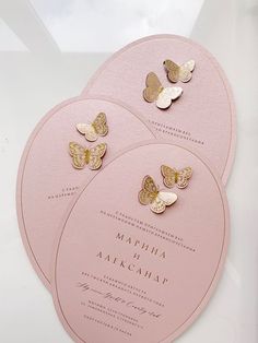 three pink wedding cards with gold butterflies on them