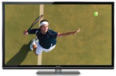 a man is playing tennis on the television