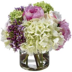 a vase filled with lots of purple and white flowers