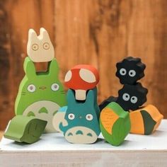 four wooden toy animals sitting next to each other