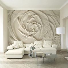 a living room with white furniture and a large wall mural