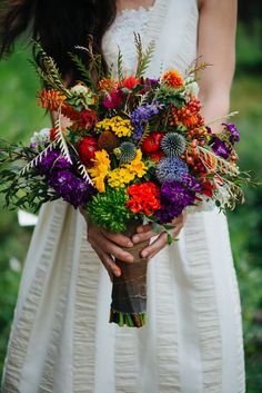 a woman holding a bouquet of flowers in her hands