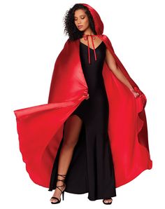 a woman in a red cape and black dress is standing with her hands on her hips