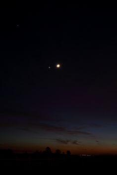 the moon and venus are visible in the night sky