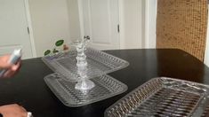 two clear trays sitting on top of a black table