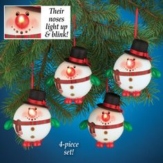 three snowmen ornament ornaments hanging from a christmas tree with the words, their noses light up & think