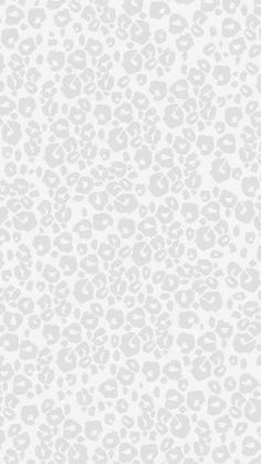 an animal print wallpaper pattern in grey and white with black spots on the left side